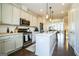 Modern kitchen features a center island, stainless appliances, white cabinetry, and a seamless open layout at 2624 Caruso Way, Atlanta, GA 30339