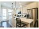 Bright kitchen featuring stainless steel appliances, a breakfast bar with seating, and modern pendant lighting at 2624 Caruso Way, Atlanta, GA 30339