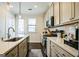 Well-lit kitchen with stainless steel appliances, ample cabinet space, and a view to the outside at 2624 Caruso Way, Atlanta, GA 30339