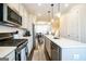 Contemporary kitchen featuring stainless appliances, quartz countertops, an island with seating, and ample cabinets at 2624 Caruso Way, Atlanta, GA 30339