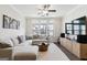 Inviting living room featuring large windows, dark hardwood flooring, and a comfortable sectional sofa at 2624 Caruso Way, Atlanta, GA 30339