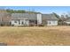 Backyard featuring a gray home exterior, wood deck, and a spacious lawn at 40 Berkshire Run, Covington, GA 30016