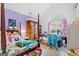 Bedroom with a four-poster bed, purple accent wall, and arched window at 40 Berkshire Run, Covington, GA 30016