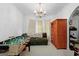 Spacious bonus room with a foosball table, neutral carpet, and chandelier lighting at 40 Berkshire Run, Covington, GA 30016