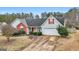 Charming single-story home features a red brick accent, landscaped yard, and attached two-car garage at 40 Berkshire Run, Covington, GA 30016