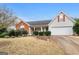 Charming single-story home with well-maintained landscaping and an attached two-car garage at 40 Berkshire Run, Covington, GA 30016