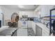 Bright kitchen with white cabinetry, stainless steel appliances, and a connected dining area at 40 Berkshire Run, Covington, GA 30016