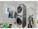 Laundry room equipped with a stacked washer and dryer, and hanging clothes at 40 Berkshire Run, Covington, GA 30016