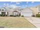 Charming two-story home with a stone facade, well-manicured lawn, and two car garage at 7764 Parkside Dr, Lithia Springs, GA 30122