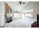 Bright living room featuring a fireplace, high ceilings, and an open layout to the kitchen at 7764 Parkside Dr, Lithia Springs, GA 30122