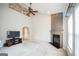 Spacious living room with fireplace, ceiling fan, and tall ceiling and an open layout at 7764 Parkside Dr, Lithia Springs, GA 30122