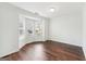 Empty living room with hardwood floors and bay windows letting in natural light at 7764 Parkside Dr, Lithia Springs, GA 30122