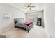 Comfortable primary bedroom features tray ceilings, a ceiling fan, and large windows at 7764 Parkside Dr, Lithia Springs, GA 30122