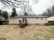 A view of the home's backyard, with a small wooden deck and a sliding glass door at 2060 Sanders Dr, Austell, GA 30168