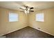 Cozy bedroom featuring two windows and a ceiling fan at 2060 Sanders Dr, Austell, GA 30168