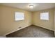 Comfortable bedroom with neutral carpet and two windows at 2060 Sanders Dr, Austell, GA 30168