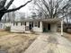 Exterior view of a single-story home with a covered parking area and front porch at 2060 Sanders Dr, Austell, GA 30168