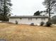 View of backyard and home with large grassy space at 29 Hickory Ct, Dallas, GA 30157