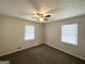 This bedroom features two windows for natural light and a ceiling fan at 29 Hickory Ct, Dallas, GA 30157