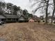 A front yard featuring landscaping and neighboring homes at 7619 Ward Ln, Jonesboro, GA 30236