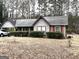 Charming single-story home featuring red trim, a gray facade, and established landscaping at 7619 Ward Ln, Jonesboro, GA 30236