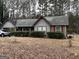 Charming single-story home featuring red trim, a gray facade, and established landscaping at 7619 Ward Ln, Jonesboro, GA 30236