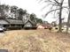 A front yard featuring landscaping, a car port and a neighboring home at 7619 Ward Ln, Jonesboro, GA 30236