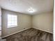 Cozy bedroom with plush carpeting and window bringing in natural light at 2846 Cocklebur Rd, Decatur, GA 30034