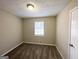 Neutral bedroom featuring a window, carpet, and an overhead light fixture at 2846 Cocklebur Rd, Decatur, GA 30034