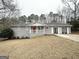 Classic home featuring grey brick, white trim, covered entrance, and a double-door garage at 2846 Cocklebur Rd, Decatur, GA 30034