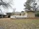 A view of the backyard, with a large deck and mature trees at 3647 Brookcrest Cir, Decatur, GA 30032