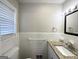 Clean bathroom featuring a granite vanity, white tile, and updated fixtures at 3647 Brookcrest Cir, Decatur, GA 30032