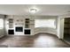 Spacious living room with wood floors, brick fireplace with shelves, and lots of natural light at 3647 Brookcrest Cir, Decatur, GA 30032