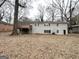 Backyard view with a wooden deck, gray brick exterior, and mature trees at 4568 Dorset Cir, Decatur, GA 30035