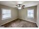 Bright bedroom with neutral carpet, ceiling fan, and large windows at 1785 San Gabriel Ave, Decatur, GA 30032