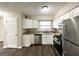 Well-lit kitchen featuring granite countertops, stainless steel appliances, and ample white cabinetry at 1785 San Gabriel Ave, Decatur, GA 30032
