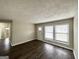 Bright living room with hardwood floors, a white front door, and large windows providing natural light at 1785 San Gabriel Ave, Decatur, GA 30032