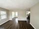 Cozy living room featuring sleek, dark hardwood floors and neutral paint with open sight lines at 1785 San Gabriel Ave, Decatur, GA 30032