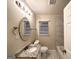 Well-lit bathroom with stylish vanity, granite counters, and tiled shower at 191 Florida Sw Ave, Atlanta, GA 30310