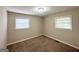 Bedroom featuring neutral carpet, fresh paint, and two windows offering natural light at 1986 Bandera Dr, Decatur, GA 30032