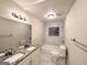 Modern bathroom with double vanity, granite counters, and a tiled shower-tub combination at 320 Brooks Sw Ave, Atlanta, GA 30310