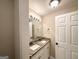 Bright bathroom featuring a granite countertop with double sinks and a decorative vanity mirror at 320 Brooks Sw Ave, Atlanta, GA 30310