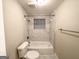 Clean bathroom featuring a tub and shower with tile surround, and neutral colored walls at 320 Brooks Sw Ave, Atlanta, GA 30310