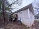 Rear exterior featuring a wood deck, neutral siding, and mature trees surrounding the home at 320 Brooks Sw Ave, Atlanta, GA 30310