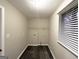 Functional laundry room with laminate floors, a storage shelf, and a window for natural light at 320 Brooks Sw Ave, Atlanta, GA 30310