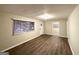 Inviting living room featuring wood flooring, neutral walls, and natural light from a large window at 320 Brooks Sw Ave, Atlanta, GA 30310