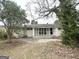 Backyard view of a home featuring a screened in porch and mature trees at 3415 Homera Pl, Decatur, GA 30032