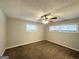 Bedroom with ceiling fan, two windows, and neutral brown carpet at 3415 Homera Pl, Decatur, GA 30032