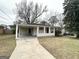 Traditional single story home with covered entry, driveway and mature trees at 3415 Homera Pl, Decatur, GA 30032