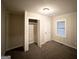 Bedroom with neutral walls and carpet, featuring a closet and window at 648 Ozburn Nw Rd, Atlanta, GA 30318